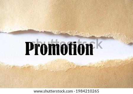 Promotion word written under white torn paper
