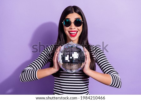 Photo of young happy excited crazy smiling korean girl in funky glasses hold disco ball isolated on purple color background