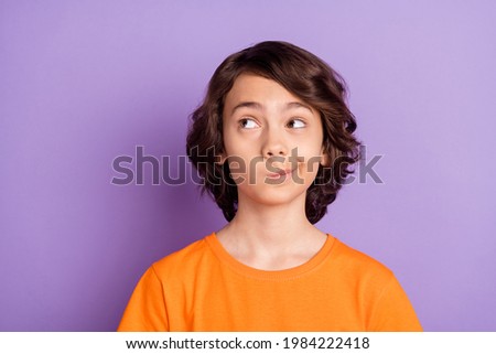 Portrait of attractive curious brown-haired boy schoolkid overthinking copy space isolated over violet purple color background Royalty-Free Stock Photo #1984222418
