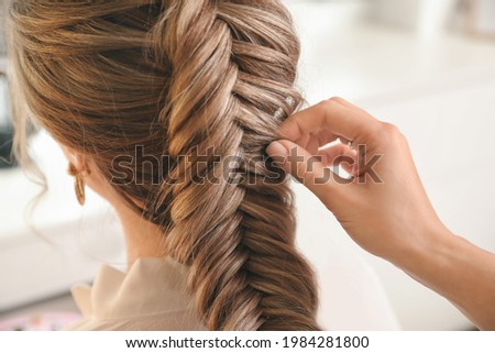 Hairdresser working with client in beauty salon Royalty-Free Stock Photo #1984281800