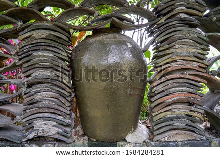 Close-up of wine jars placed outdoors in rural China