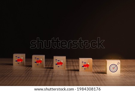 Goal and target, success and business target concept. Wood block on table with arrow icon about business strategy and Action plan. business development and copy space.