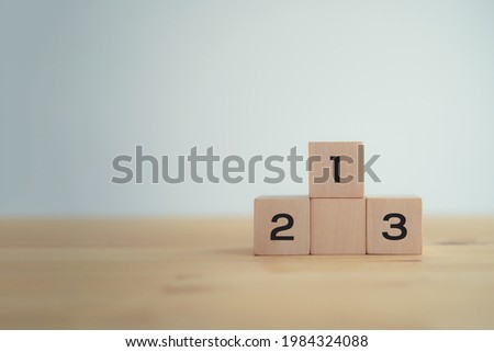 Wooden blocks stacking as a podium on white background. Target of success, win, winner, victory or top ranking concept, business success concept, education concept, competition concept Royalty-Free Stock Photo #1984324088