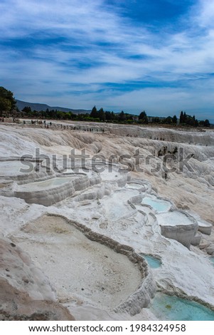 Carbonate mineral cliff with calcite-laden waters in Hierapolis Pamukkale in Turkey. Pamukkale is meaning cotton castle in Turkish, is a natural site in Denizli Province.