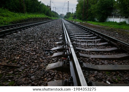 Railroad and wet concrete sleepers at rain. Close up photo.