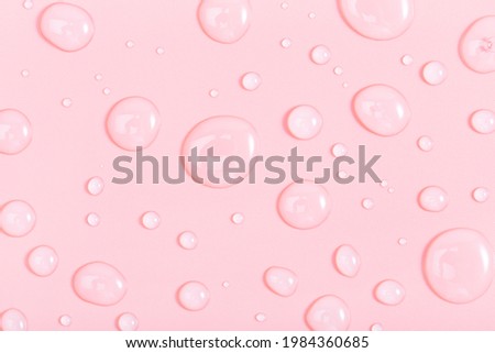 cosmetic liquid transparent gel with bubbles on pink background. Flat lay style. Royalty-Free Stock Photo #1984360685