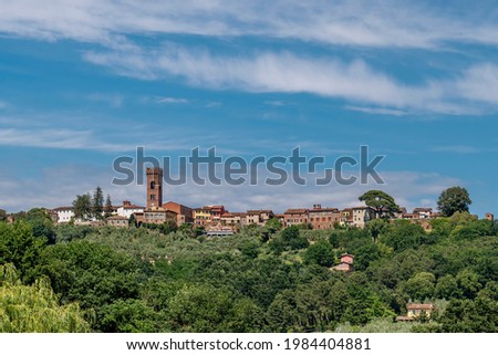 Panoramic view of the ancient Tuscan village of Montecarlo di Lucca, Italy, under a beautiful sky