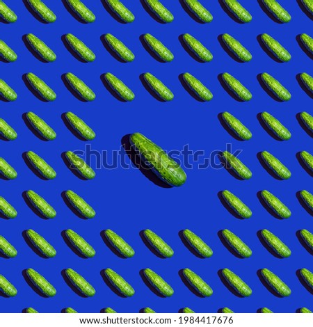 Seamless texture background pattern of fresh green cucumbers on a blue background