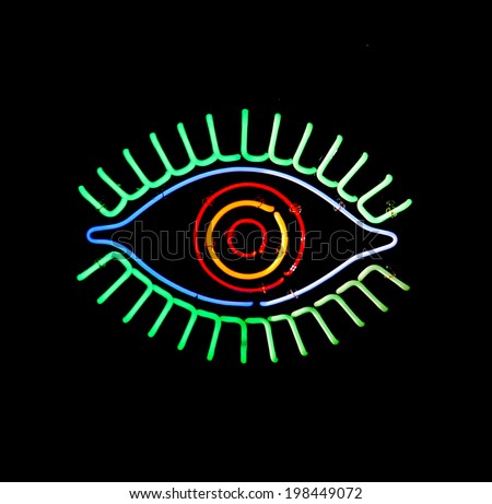 a glowing neon eye sign on a black background