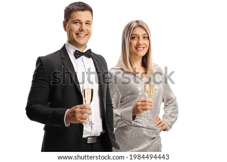 Young man and woman in elegant clothes holding glasses of sparkling wine isolated on white background