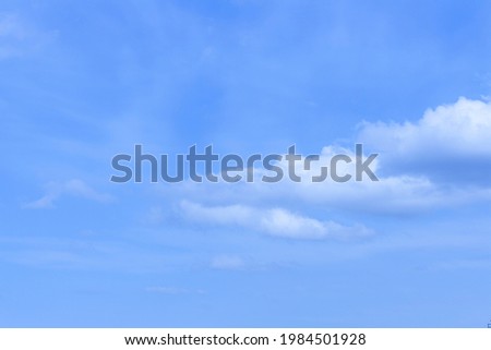 Cumulus clouds against a blue sky.