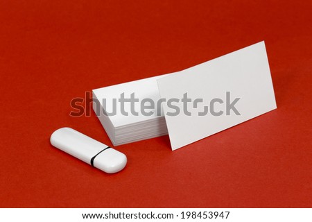 Business card template mockup for branding identity with blank modern devices and modern abstract or hipster logo print. Isolated on red paper background.
