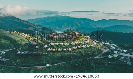 Aerial view of camping grounds and tents on Doi Mon Cham mountain in Mae Rim, Chiang Mai province, Thailand Royalty-Free Stock Photo #1984618853