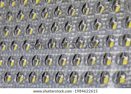 Background of glass glass transparent of LED lamp or panel with yellow light emitting diodes elements inside. selective focus