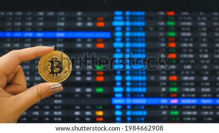 Cryptocurrency symbol bitcoin. Gold Digital Currency Money Investing in virtual assets. Hand hold Golden bitcoin Investment market trend financial world cryptocurrency and technology Concept.