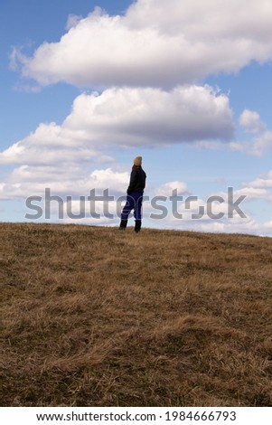 natural landscape a lonely man builds against the sky with clouds in early spring
