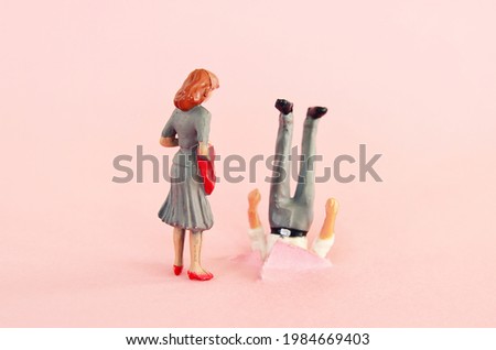 woman looking at clumsy man. funny concept of married couple or romantic relationship Royalty-Free Stock Photo #1984669403