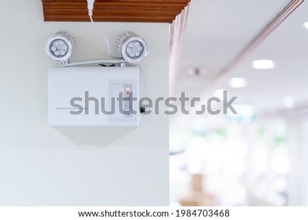 Automatic EMERGENCY LIGHT in hospital is charging and power pluging on the wall that ready to use when the power went out.