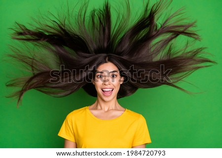 Photo of amazed happy excited young woman fly hair sale surprised new isolated on green color background