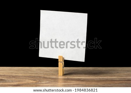 Wooden clothespin with a sheet of paper. Planning. Message.
