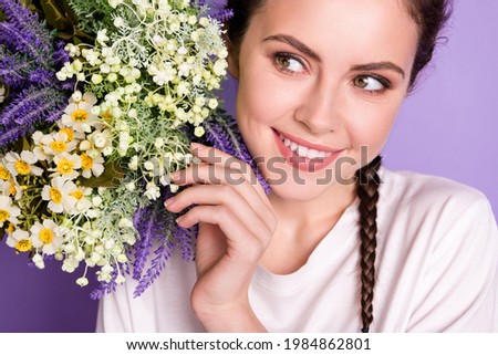 Cropped photo of young cheerful girl happy positive smile look wild flowers spring isolated over violet color background