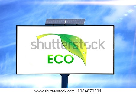 Billboard with Ecology logo flag and solar battery on blue sky background