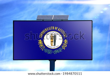 Billboard with State of Kentucky flag and solar battery on blue sky background
