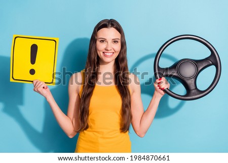 Photo portrait girl keeping steering wheel showing road sign isolated pastel blue color background