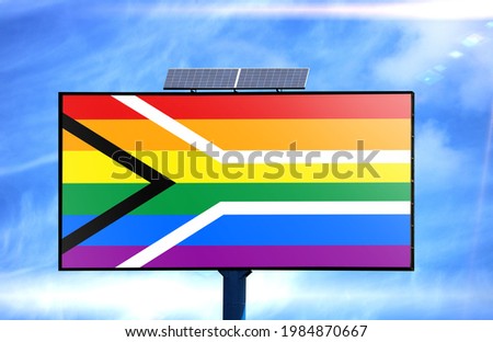 Billboard with Gay pride Flag of South Africa flag and solar battery on blue sky background