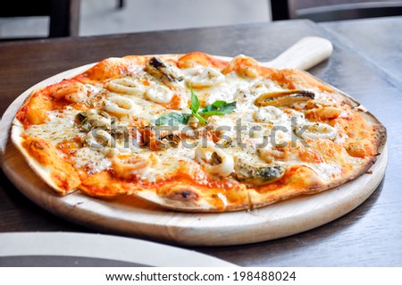 seafood pizza dish on the table