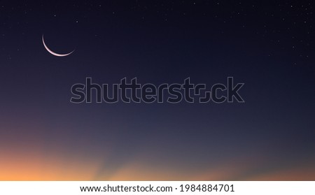 Crescent moon on dusk sky twilight background,symbols of Islamic religion well text Arabic on free space