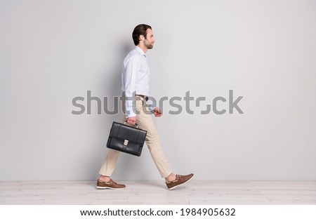 Full length body size profile side view of nice imposing classy man director walking office isolated over grey pastel color background