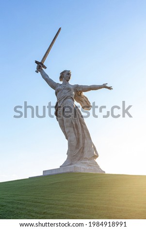 The Motherland Calls monument in Mamayev Hill War Memorial at sunset in Volgograd city, Russia. Clear blue sky. It  is the tallest statue in Europe. Russian culture theme. Royalty-Free Stock Photo #1984918991