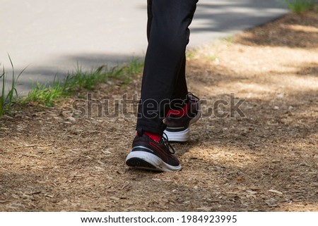 A man runs around the park. Playing sports on the street.