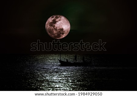 Picture of a fishing boat in the sea and the moon in Thailand
