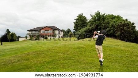 Composition of caucasian man playing golf striking with golf club. championships, sports and competition concept digitally generated image.