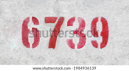 Red Number 6743 on the white wall. Spray paint.
