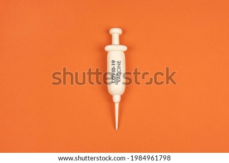 Vaccination concept design. Syringe with vaccine for COVID-19  on red background. Discussion about covid-19 vaccination. Decision about vax.