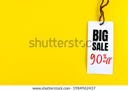 Big sale 90% off price tag with white string on yellow background