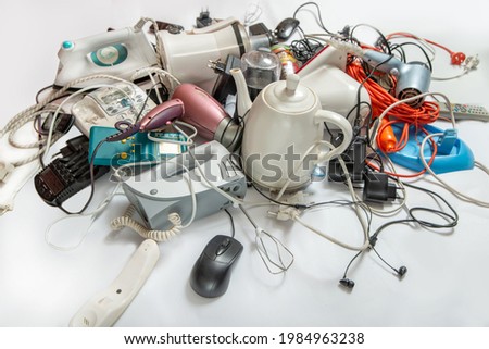 Lots of old electrical appliances for recycling e-waste. Sustainable living concept.  Royalty-Free Stock Photo #1984963238