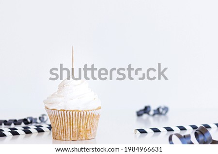 1 white cupcake with topper stick and blank white background. Black  party supplies and paper straws Black Cupcake topper mock up