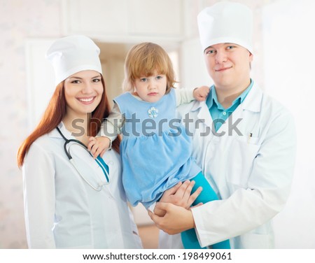 friendly doctors with baby girl in the clinic Royalty-Free Stock Photo #198499061
