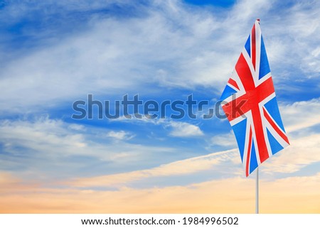 The national flag of the United Kingdom against blue sky