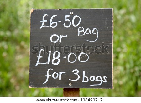 A sign indicating prices for goods in the farm shop