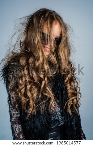 kid in glasses with stylish long curly hair hairstyle, hairdresser