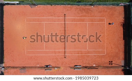clay tennis courts in a garden