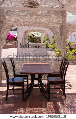 Wooden table and chairs in beach cafe next to the red sea in Sharm el Sheikh, Egypt, close up