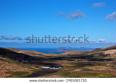 View to a valley in the north of Lanzarote with islands and the sea