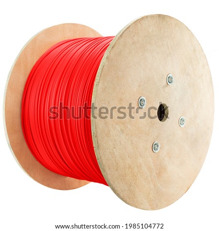 Roll of outdoor fiber optic signal shielded cable is on a white background  Wooden Coils of powerful red telecommunications wire  Royalty-Free Stock Photo #1985104772