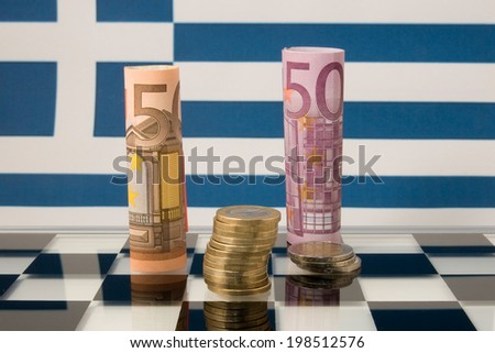 Euros on a chessboard and the Greek flag in the background Royalty-Free Stock Photo #198512576